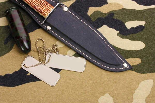 Army badges and knife on camouflage background — Stock Photo, Image