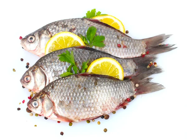 stock image Fresh fishes with lemon, parsley and spice isolated on white