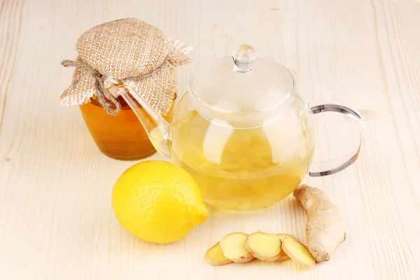 Υγιή τσάι τζίντζερ σε κατσαρόλα με λεμόνι και μέλι σε ξύλινα φόντο — Φωτογραφία Αρχείου