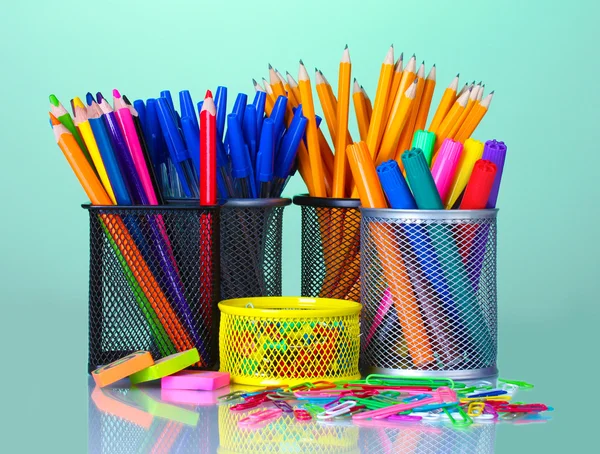 Colored holders for office supplies with them on bright background — Stock Photo, Image