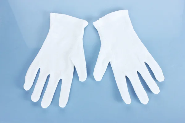 Rękawice tkaniny na niebieskim tle — Zdjęcie stockowe