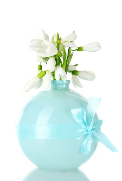 Stock image Beautiful bouquet of snowdrops in blue vase isolated on white