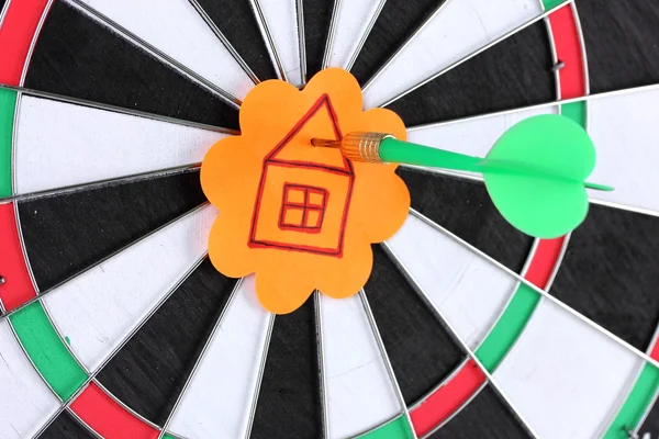 Darts with stickers depicting the life values close-up on white background — Stock Photo, Image