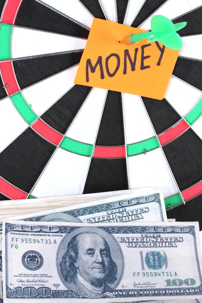 Darts with a sticker symbolizing money close-up — Stock Photo, Image