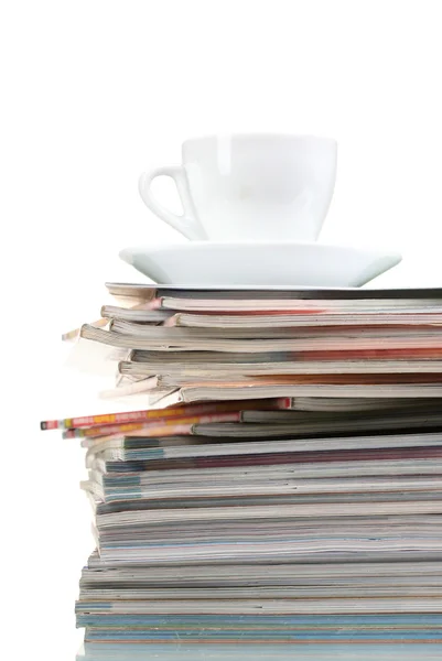 stock image Stack of magazines and cup isolated on white