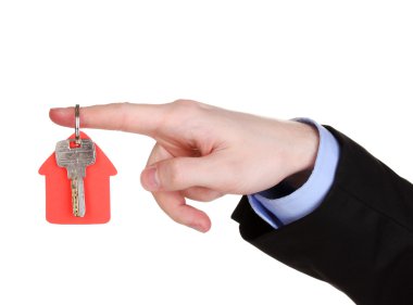 Key with house-shaped charm in hand isolated on white clipart