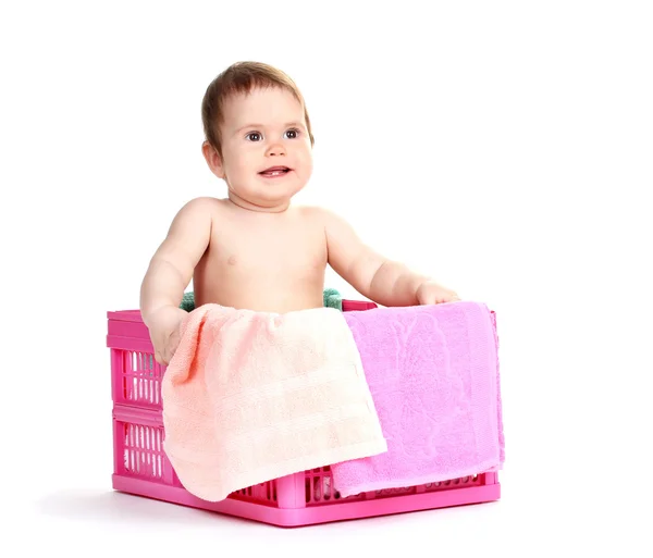Menina bonito sentado na cesta de lavanderia isolado no branco — Fotografia de Stock