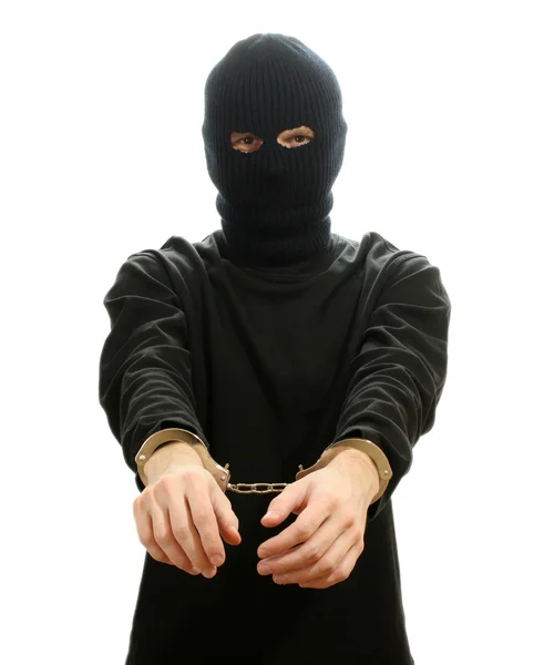 Bandido em máscara preta algemado isolado em branco — Fotografia de Stock