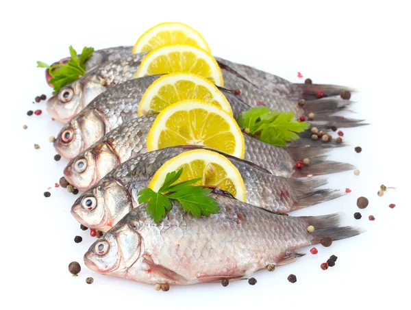 Peixes frescos com limão, salsa e especiarias isolados em branco — Fotografia de Stock