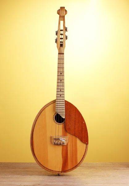 stock image Retro kobza- Ukrainian musical instrument on wooden table on yellow background