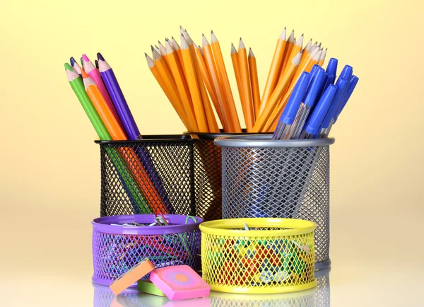 Color holders for office supplies with them on bright background — Stock Photo, Image