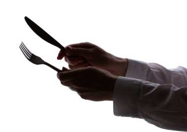 Silhouette of woman's hands with fork and knife isolated on white clipart