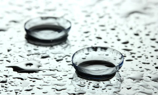 stock image Contact lens with drops on grey background