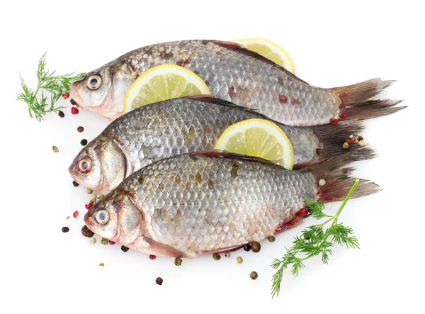 stock image Fresh fishes with lemon, parsley and spice isolated on white