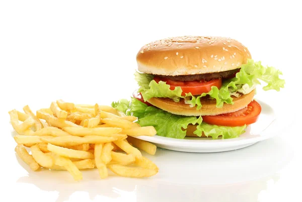 Big and tasty hamburger on plate and fried potatoes isolated on white — Stock Photo, Image