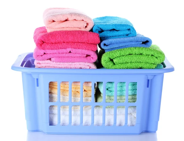 Plastic basket with bright towels isolated on white — Stock Photo, Image