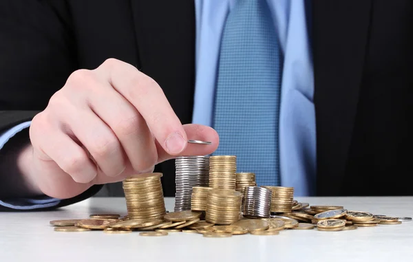 stock image Businessman put coins isolated on white