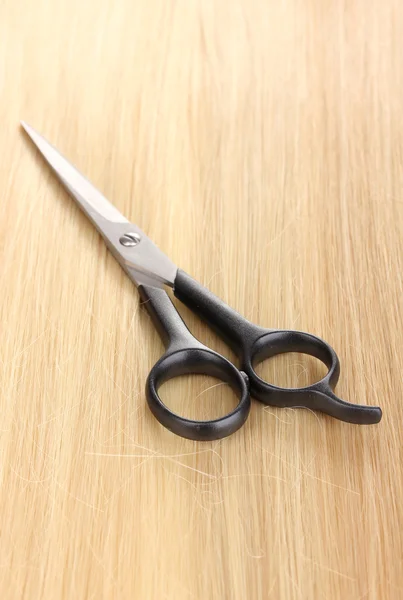 Shiny blond hair and hair cutting shears close-up — Stock Photo, Image
