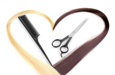 Shiny blond and brown hair with hair cutting shears and comb isolated on white