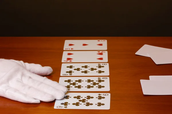 Cards and hand on brown background — Stock Photo, Image