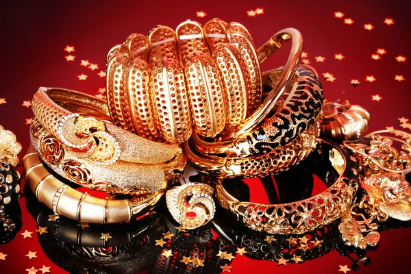 stock image Beautiful golden jewelry on red background