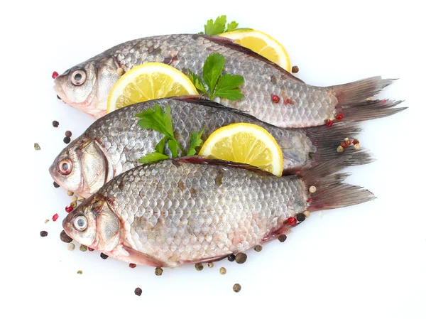 Fresh fishes with lemon, parsley and spice isolated on white — Stock Photo, Image