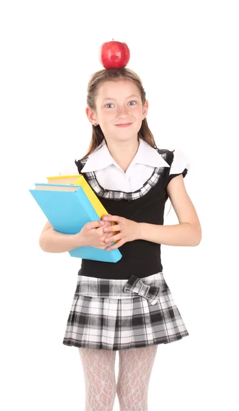 Bella bambina in uniforme scolastica con libro e mela isolata su bianco — Foto Stock