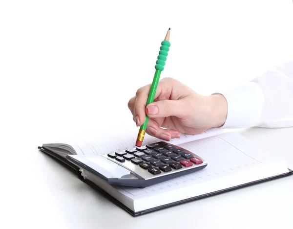 Main de femme avec crayon, cahier et calculatrice isolé sur blanc — Photo