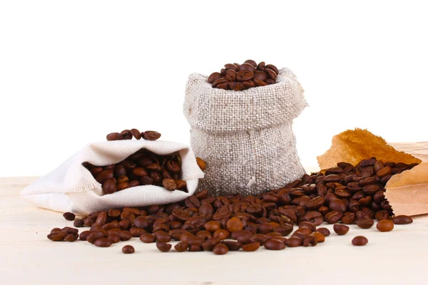 Canvas sack with coffee beans and the paper bag with coffee isolated on white — Stock Photo, Image
