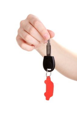 Car key with charm in hand isolated on white clipart