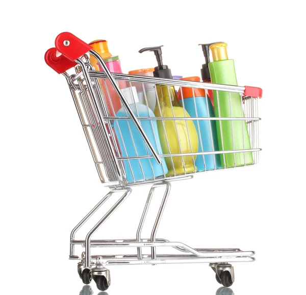 Carrito de compras con botellas de detergente aisladas en blanco —  Fotos de Stock