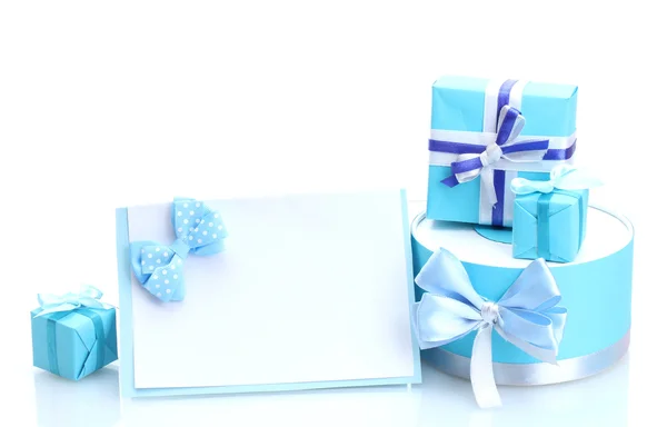 Stock image Blue gifts with bows and blank postcard isolated on white