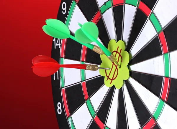 Darts with stickers depicting the life values close-up on colorful background — Stock Photo, Image