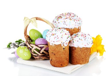 Beautiful Easter cakes, colorful eggs in basket and flowers isolated on white clipart