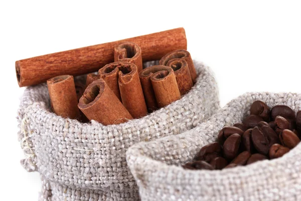 Coffee beans and cinnamon in canvas sacks close-up — Stock Photo, Image
