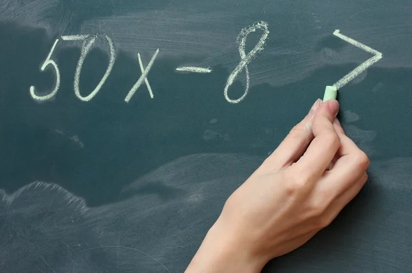 Hand writing mathematical test on the blackboard — Stock Photo, Image