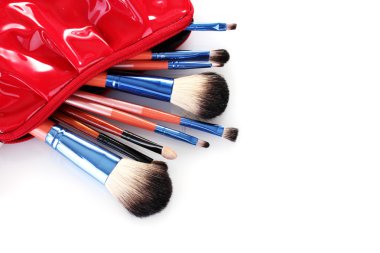 Make-up brushes in cosmetics bag isolated on white clipart
