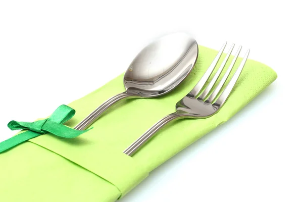 Fork and spoon in a green cloth with a bow isolated on white — Stock Photo, Image