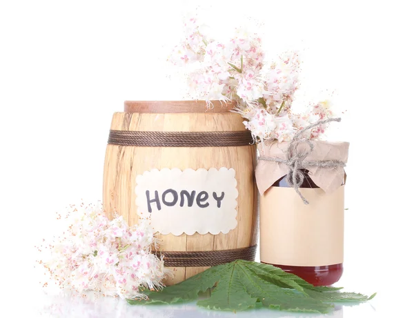 A barrel and a jar of honey and chestnut flowers isolated on white background