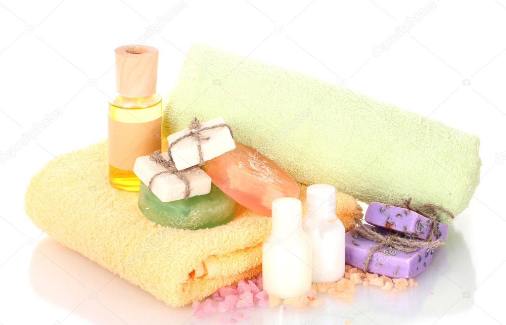 Bottle of oil, soaps, sea salt and towels isolated on white