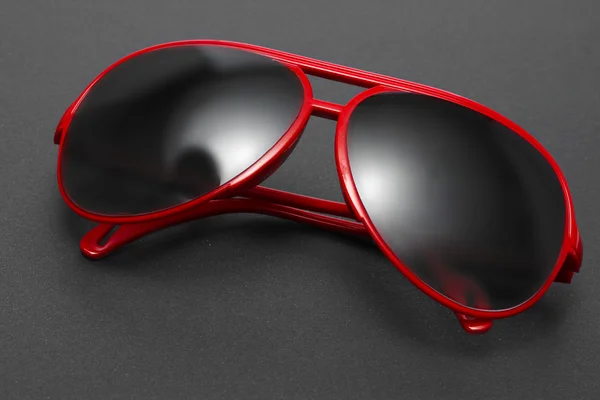 Lunettes de soleil glamour rouge femme sur fond gris — Photo