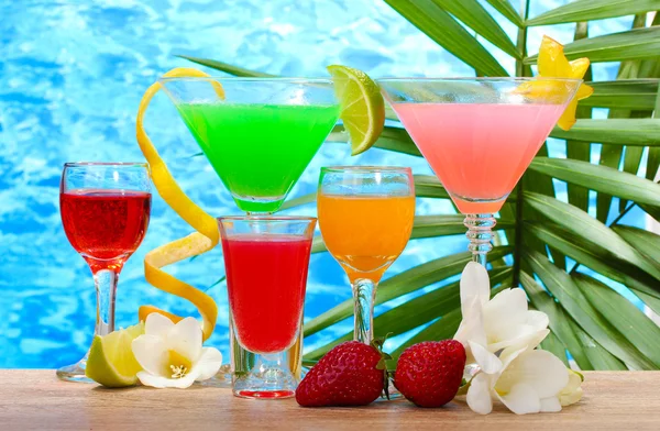 Exotiska drinkar och blommor på bordet på blå havet bakgrund — Stockfoto