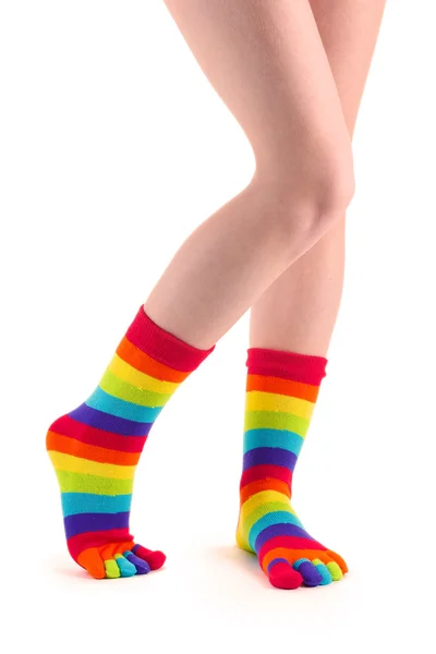 Piernas femeninas en calcetines a rayas de colores aislados en blanco —  Fotos de Stock