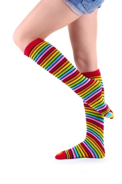 Female legs in colorful striped socks isolated on white — Stock Photo, Image