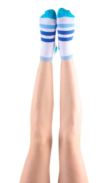 Pernas femininas em meias listradas isoladas em branco — Fotografia de Stock