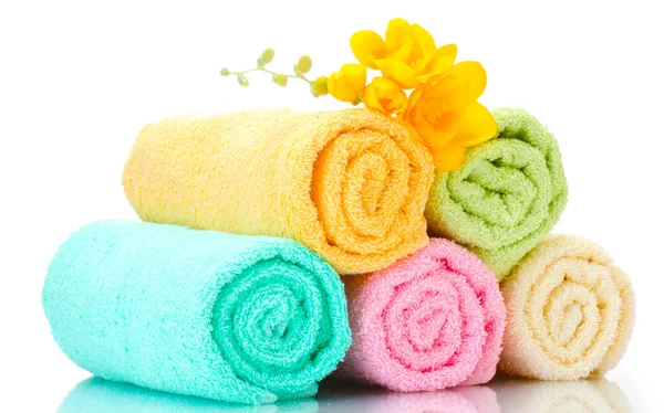 Colorful towels and flowers isolated on white Stock Image