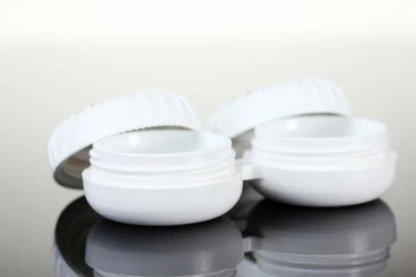 Kontaktlinser i behållare på grå bakgrund — Stockfoto