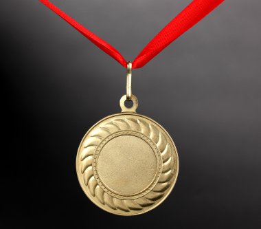 Gold medal on grey background clipart