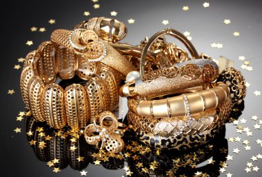 Beautiful golden jewelry on grey background clipart