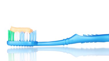 Toothbrush with paste isolated on white clipart